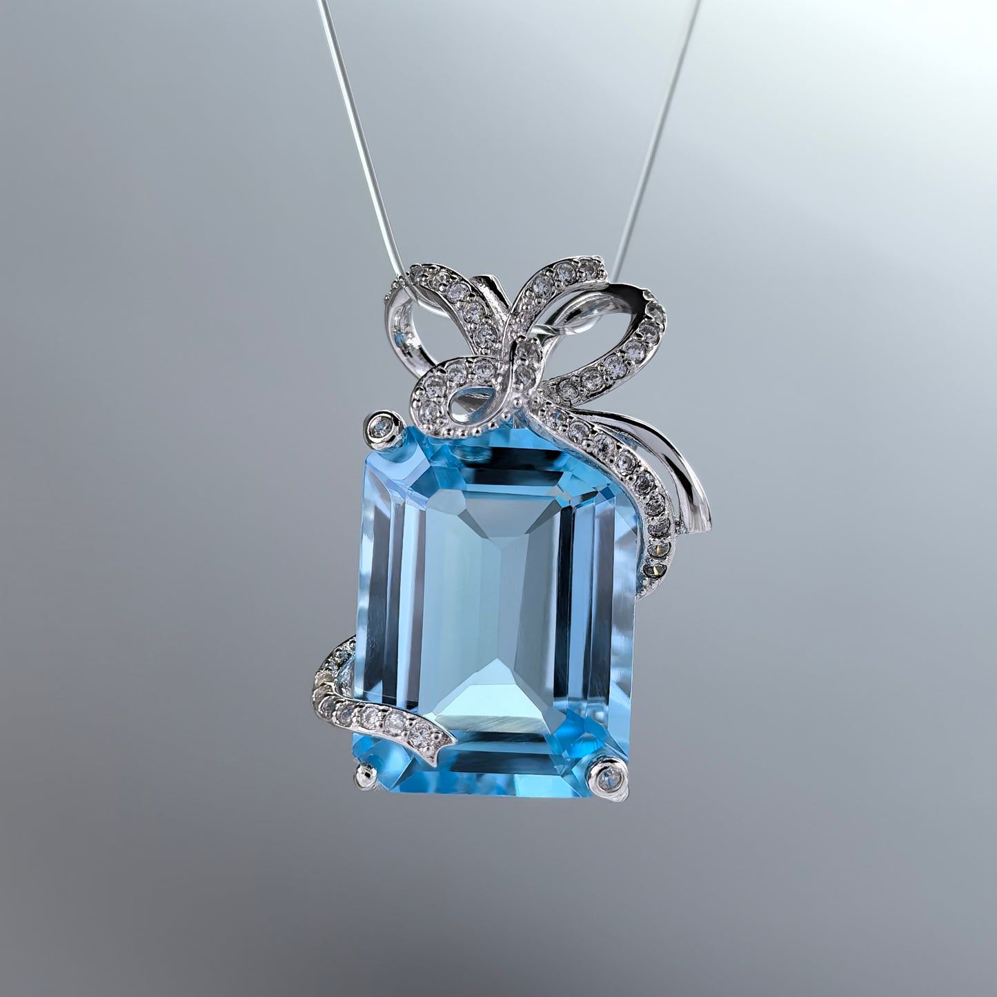 Elegant Rhodium Plated 925 Sterling Silver Natural Sky Blue Topaz Bow Pendant