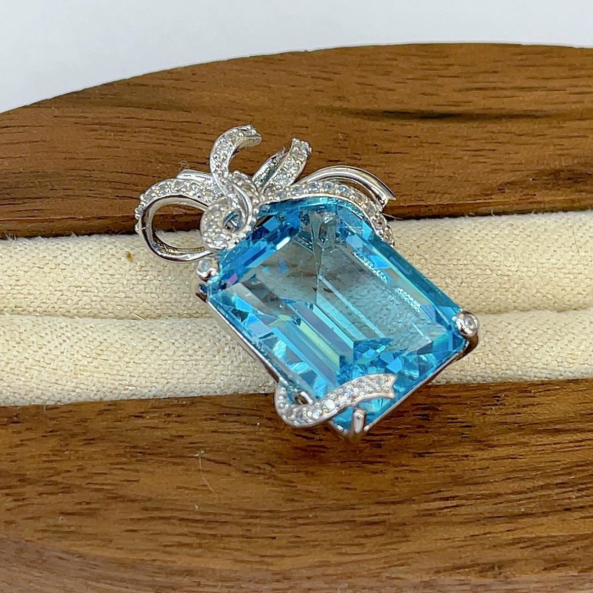Elegant Rhodium Plated 925 Sterling Silver Natural Sky Blue Topaz Bow Pendant